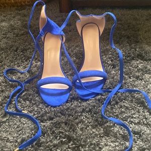 Blue high heels. Tie up laces.